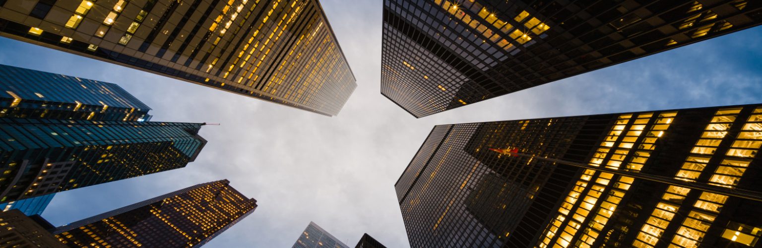 Business and finance concept, looking up at modern office building architecture and high rise corporate buildings in the financial district, Downtown Toronto, Ontario, Canada.